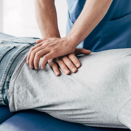 A chiropractor giving a back adjustment.