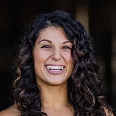 Ciara Elena smiling, she has dark curly hair.