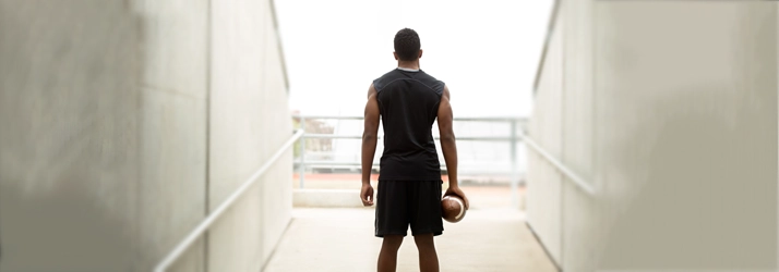 Concussion Irvine CA Football Player A football player standing looking at the stadium.