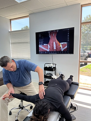 Chiropractor Nicholas Hoy adjusting a patients arm.
