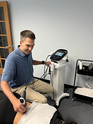 Concussion Irvine CA Nicholas Hoy With SoftWave Patient Chiropractor Nicholas Hoy with a SoftWave therapy patient.